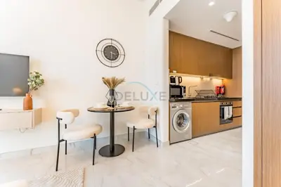 a kitchen and dining room with a table and chairs at Just Minutes Drive From Dubai Autodrome, Conveniently Located Within A Short Walk Of The Bus Stop, Azizi Vista, Dubai Studio City by Deluxe Holiday Homes in Dubai
