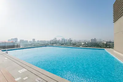 a large swimming pool on top of a building at Just Minutes Drive From Dubai Autodrome, Conveniently Located Within A Short Walk Of The Bus Stop, Azizi Vista, Dubai Studio City by Deluxe Holiday Homes in Dubai