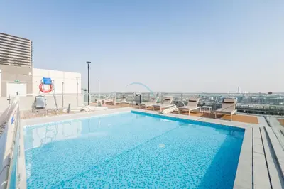 a swimming pool on the roof of a building at Just Minutes Drive From Dubai Autodrome, Conveniently Located Within A Short Walk Of The Bus Stop, Azizi Vista, Dubai Studio City by Deluxe Holiday Homes in Dubai