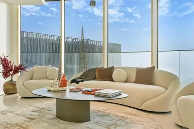 a living room with a couch and a table at BLVD Beachfront Living with Skyline View in Dubai