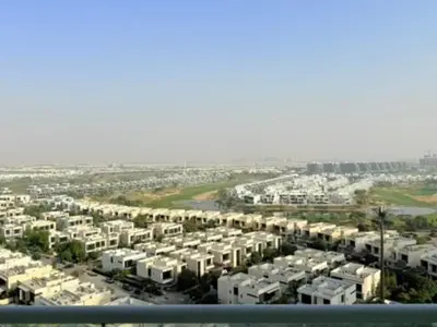 an aerial view of a city with white buildings at Mahenti - Stunning Golf View Studio in Damac Hills in Dubai