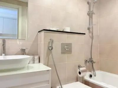 a bathroom with a shower and a sink and a tub at Mahenti - Stunning Golf View Studio in Damac Hills in Dubai