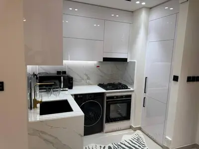 a white kitchen with a stove and a sink at Luxury Skyline View Apartment - Binghatti Tulip 1401 in Dubai