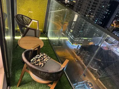 a table and chairs sitting on top of a building at Luxury Skyline View Apartment - Binghatti Tulip 1401 in Dubai