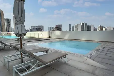 a swimming pool on the roof of a building at High Floor JVC 1BR Skyline Showstopper in Dubai