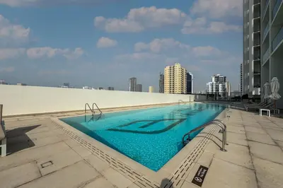 a large swimming pool on top of a building at High Floor JVC 1BR Skyline Showstopper in Dubai
