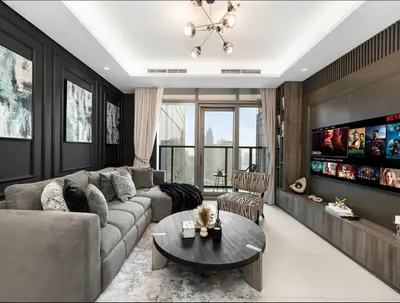 a living room with a couch and a table at Luxury 2BR - Paramount Midtown with Infinity Pool in Dubai