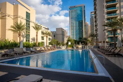 a swimming pool in the middle of a city with buildings at Luxury 2BR Haven with Panoramic Scenery in Dubai