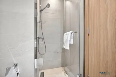 a bathroom with a shower with a glass door at Winter Wonderland Studio Azizi Riviera 9 Pool View in Dubai