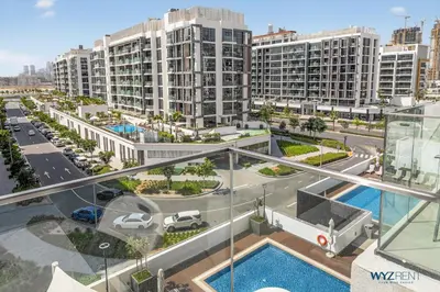an aerial view of a city with tall buildings at Winter Wonderland Studio Azizi Riviera 9 Pool View in Dubai