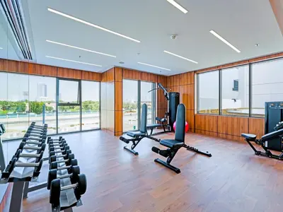 a gym with treadmills and exercise equipment in a building at Elegant Modern Studio- Peaceful Studio City in Dubai