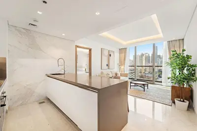 a kitchen with white countertops and a large window at FIRST CLASS 1BR Burj Views , Prime Location in Dubai