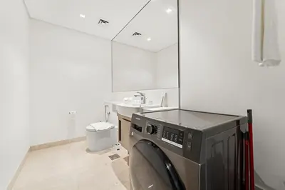a kitchen with a microwave and a sink at FIRST CLASS 1BR Burj Views , Prime Location in Dubai