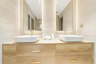 two sinks in a bathroom with two mirrors at FIRST CLASS 2BR Burj View , Walk to Dubai Mall in Dubai