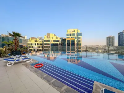 a large swimming pool on top of a building at FIRST CLASS Studio Iconic Burj Khalifa View in Dubai