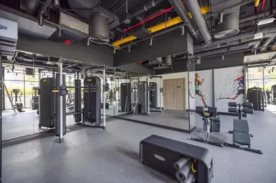 a gym with treadmills and machines in a room at Lux 1BR with Stunning Canal Views in Dubai