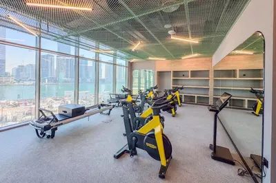 a gym with a bunch of exercise bikes in a building at Upscale Studio with Peninsula Lifestyle in Dubai