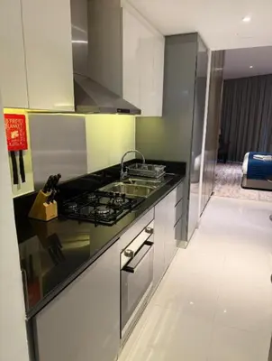 a kitchen with a sink and a stove at Exquisite Studio - Damac Prive with balcony & canal view in Dubai