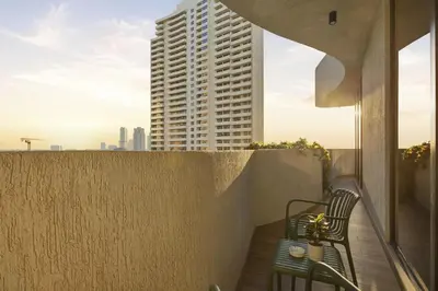 a balcony with two benches and a tall building at Chic 2Bedroom with Exceptional Facilities in JVC in Dubai