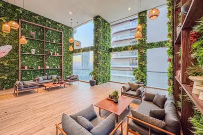 a living room with furniture and plants on the wall at Chic 2Bedroom with Exceptional Facilities in JVC in Dubai
