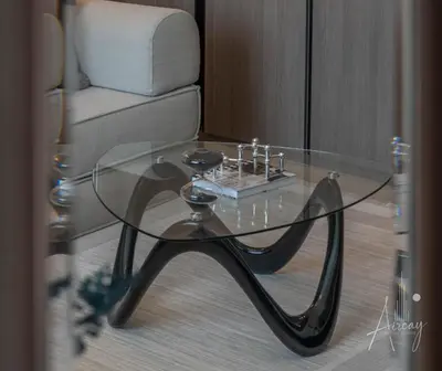 a glass coffee table in front of a couch at Sunlit Luxe Studio Serene Skies Infinity Pool in Dubai