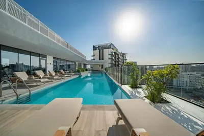 a swimming pool on the roof of a building at Sunlit Luxe Studio Serene Skies Infinity Pool in Dubai