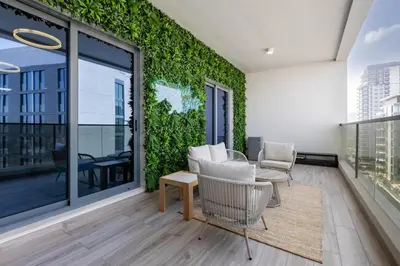 a living room with a green wall at Luxury 1 Bedroom Sway Residences Dubai Hills in Dubai