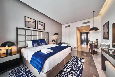 a large bedroom with a large bed and a desk at Luxury Studio Cozy & comfy 12 Min Walk-Dubai Mall in Dubai