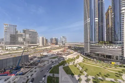 a city with tall buildings and a busy freeway at Luxury 1BR in Nobles Tower - Business Bay Skyline in Dubai