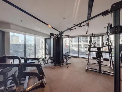 a gym with treadmills and machines in a building at Luxury 1BR in Nobles Tower - Business Bay Skyline in Dubai