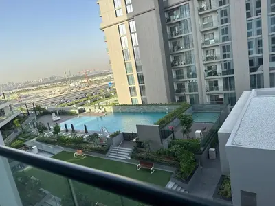 a view of a pool from a balcony in a building at Creek Comfort and Coziness in Dubai