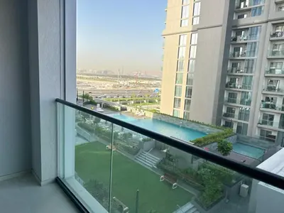 a view of a pool from a balcony in a building at Creek Comfort and Coziness in Dubai