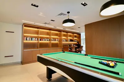 a billiard room with a pool table at Rentico l Luxury 1BR with Burj Khalifa & Canal View in Dubai