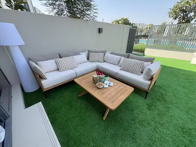 a couch and a table on a lawn at Prime Pool Location Spacious Family Villa in Dubai