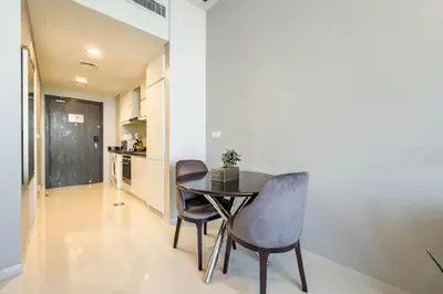 a kitchen and dining room with a table and chairs at Serene Golf Course Studio in Artesia Damac Hills in Dubai Marina