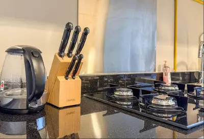 a kitchen counter with some knives in a box at Serene Golf Course Studio in Artesia Damac Hills in Dubai Marina