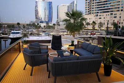 a balcony with couches and chairs and a harbor at Luxury Yacht in Dubai Marina - Private Charter in Dubai
