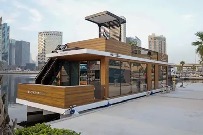 a small boat on the water in a city at Luxury Yacht in Dubai Marina - Private Charter in Dubai