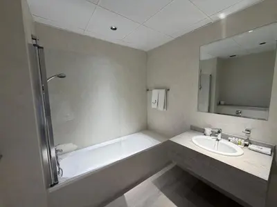 a bathroom with a bath tub and a sink at Two bedroom Apartment in JBR Marina - 2 min walk to JBR beach in Dubai