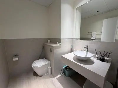 a bathroom with a sink and a toilet and a mirror at Two bedroom Apartment in JBR Marina - 2 min walk to JBR beach in Dubai