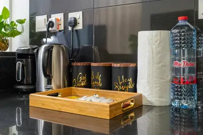 a wooden box on a counter with a bottle of water at Elegant 1BR near downtown w Gym Tennis Basketball Courts in Dubai