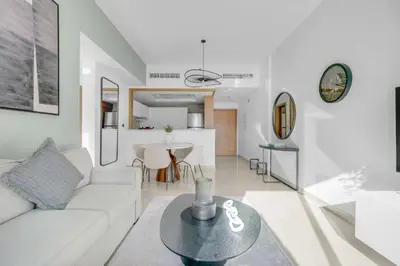 a living room with a white couch and a table at Perfect Getaway in Downtown l Near Dubai Mall in Dubai