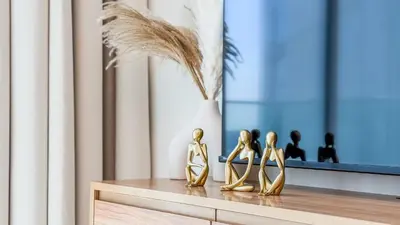 a group of gold figurines sitting on a table at TRPS - Skyz by Danube, Arjan - Close to Miracle Garden, Furnished, Brand New in Dubai