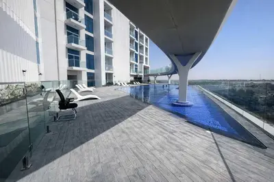 a view of a building with a swimming pool at TRPS - Skyz by Danube, Arjan - Close to Miracle Garden, Furnished, Brand New in Dubai