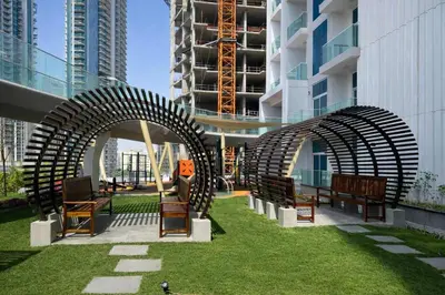 a group of benches in front of a building at TRPS - Skyz by Danube, Arjan - Close to Miracle Garden, Furnished, Brand New in Dubai