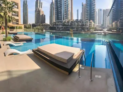 a swimming pool with two beds on top of it at Stylish Deluxe Two Bedrooms In Dubai Marina in Dubai