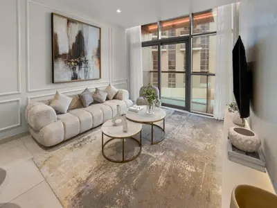 a living room with a couch and a table at Stylish Deluxe Two Bedrooms In Dubai Marina in Dubai