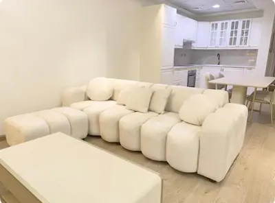 a white couch in a living room with a table at Heart of Marina with Free Parking, Pool and Gym in Dubai