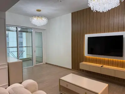 a living room with a flat screen tv and a couch at Heart of Marina with Free Parking, Pool and Gym in Dubai