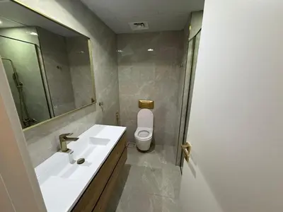 a bathroom with a sink and a toilet and a mirror at Heart of Marina with Free Parking, Pool and Gym in Dubai